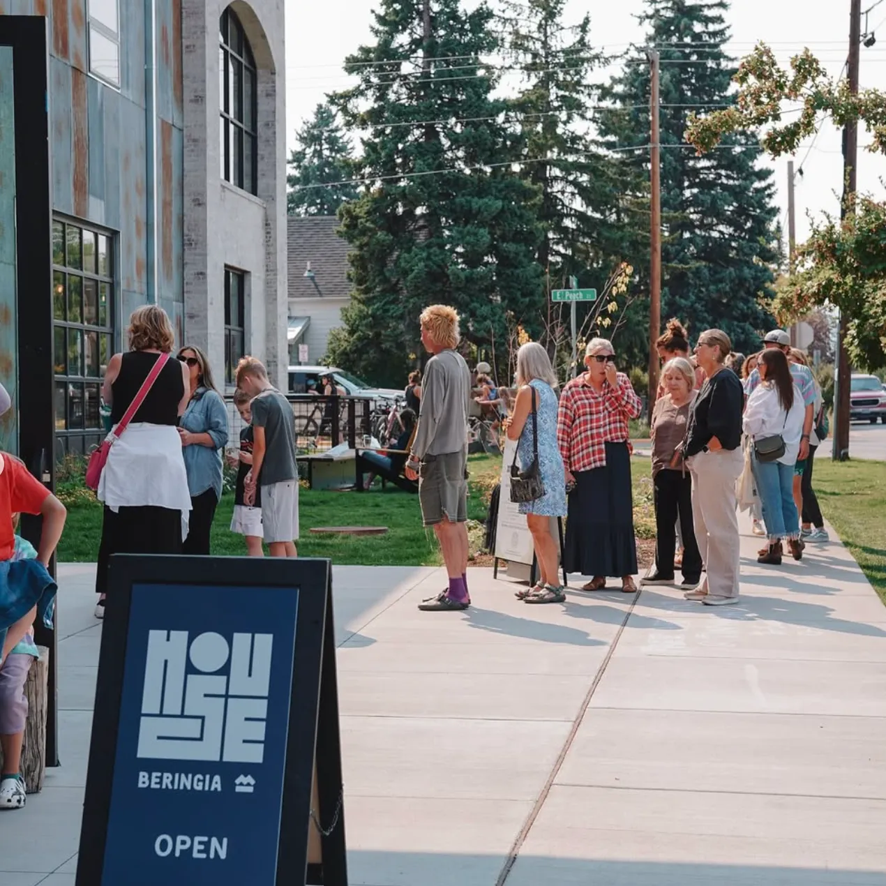 Neighbors gathered outside House Beringia on East Peach Street during a Northside event.